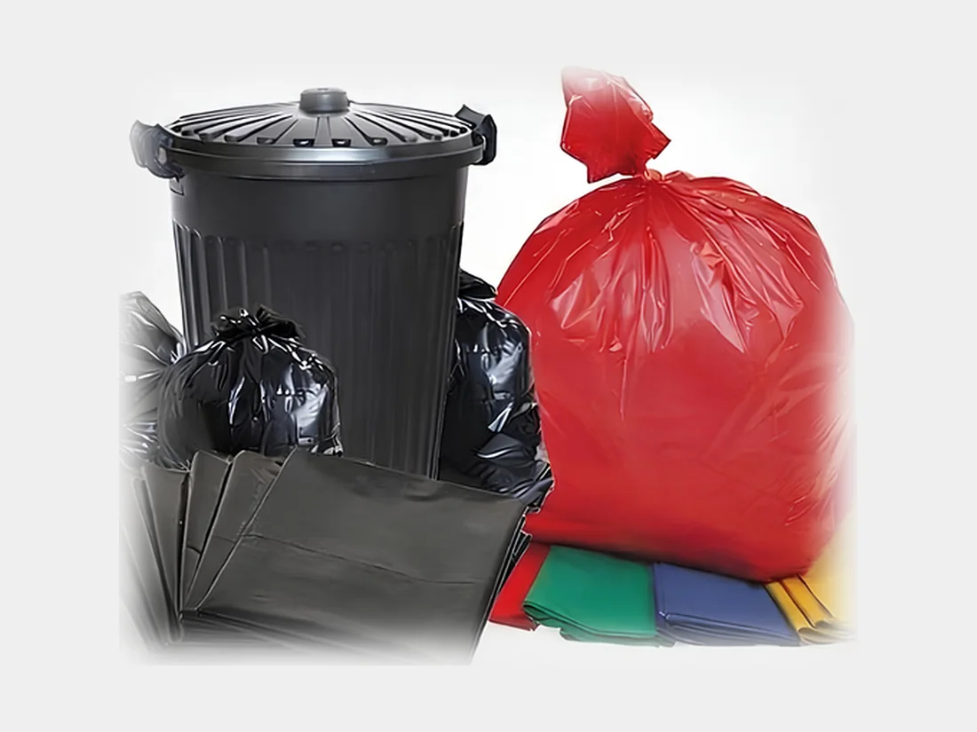 Black and coloured bin liners with a wheelie bin