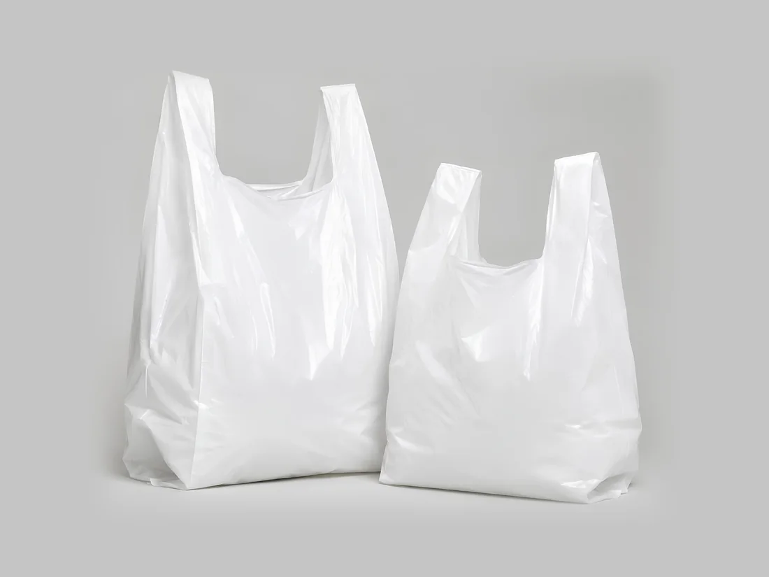 Two plain white vest carrier bags